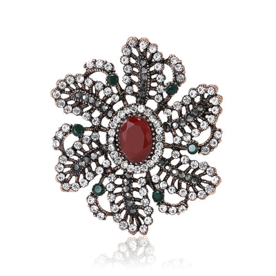 Front view of antique tone floral brooch with red center stone decorative metal pin