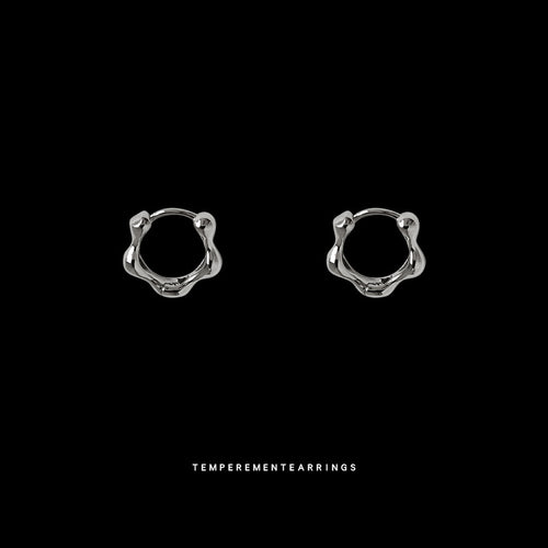 Silver wavy organic huggie hoops on black background