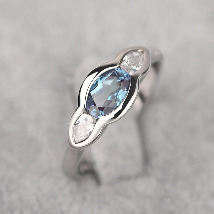 Blue Oval And Clear Round Three-Stone Ring In Silver Tone
