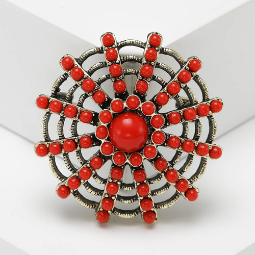 Close-up product view showing the colors and surface details of the round beaded sunburst brooch