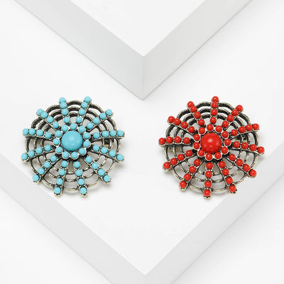 Front product view of the round beaded sunburst brooch on a light background