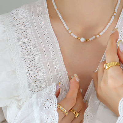 White glass bead pearl center necklace worn with lace top