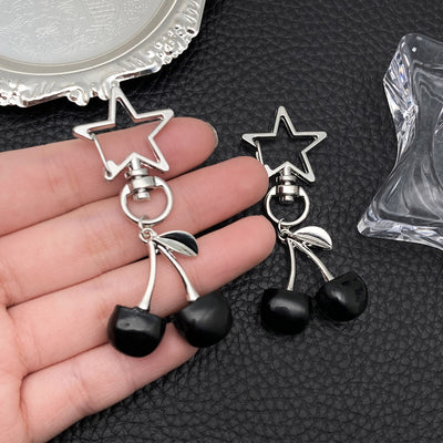 Overview showing the available color and design variations of the black and red cherry star metal clasp keychain