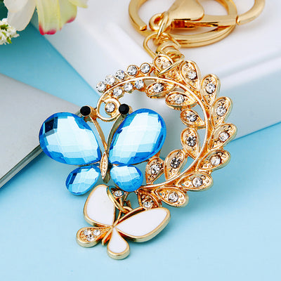 Main image 1 shows a supplied presentation of blue crystal butterfly pair keychain with visible attached key hardware.