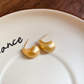 Brushed Gold Tone Curved Teardrop Stud Earrings With Decorative Metal Accents view 6