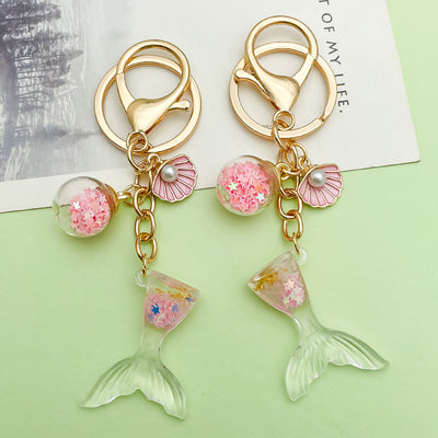 Image 1 showing starfish, shell and mermaid keychains shown in the product image.