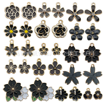 Gold-tone insect charms arranged on a light background