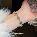 Gold Tone Bracelet With Seven Multicolor Round Crystal Halo Links view 1