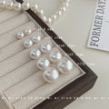 White Pearlescent Round Stud Earrings In Five Graduated Sizes view 4