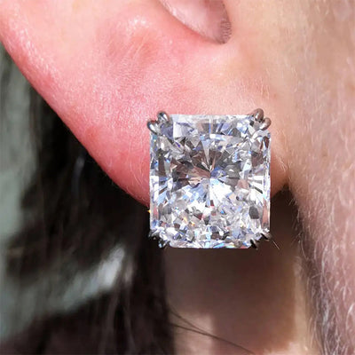 Close-up of square asscher clear stud earring worn on ear