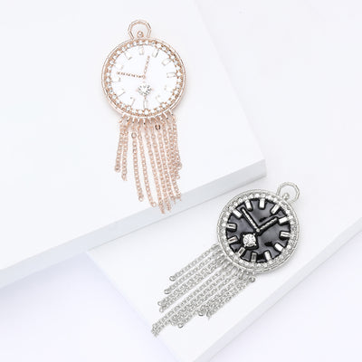 Front view of round clock face above multiple fine chain tassels