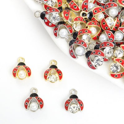 Assorted ladybug charms arranged on a white surface