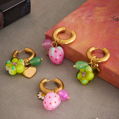Display view of resin flower and strawberry drop hoop earrings in main image 1.