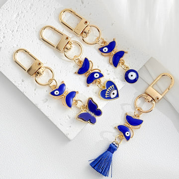 Gold Tone Blue Evil Eye Keychains with Tassels and Charm Accents