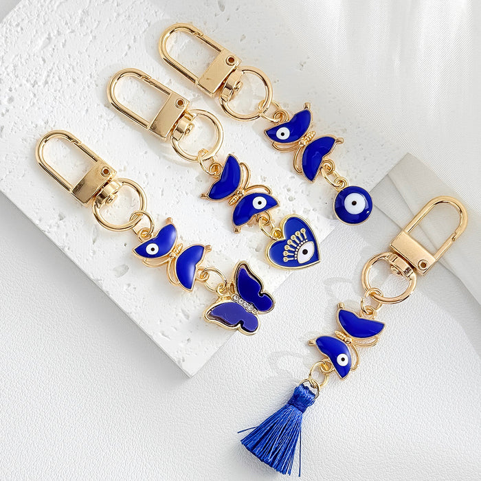 Gold Tone Evil Eye Charm Keychain with Blue Tassel and Rhinestone Accents