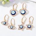 Gold Tone Crystal Heart Star and Evil Eye Hook Earrings view 1