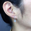 Round Crystal Huggie Drop Earrings in Silver Tone with Clear Crystal Details view 4