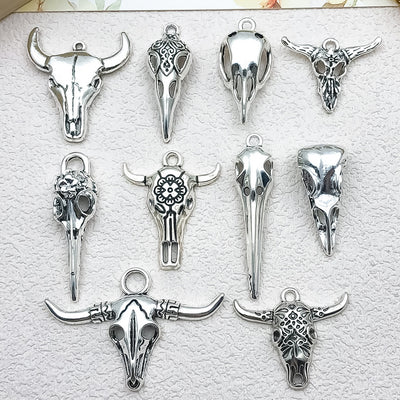 Metallic assorted shape charms arranged on a light background
