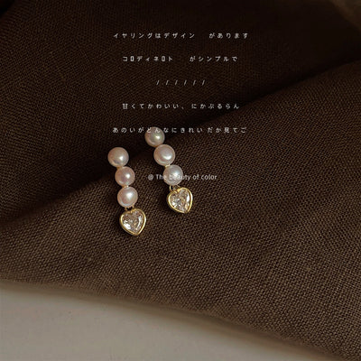 Gold-tone triple-pearl clear-heart drop studs in the first product display.
