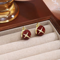 Red Enamel Four Point Star Gold Small Huggie Earrings view 3