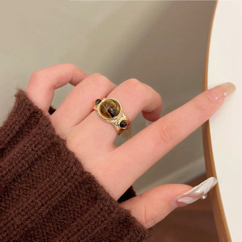 Gold tiger eye round open ring worn on index finger