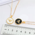 Gold Tone Black and White Winged Skull Round Pendant Necklaces view 2