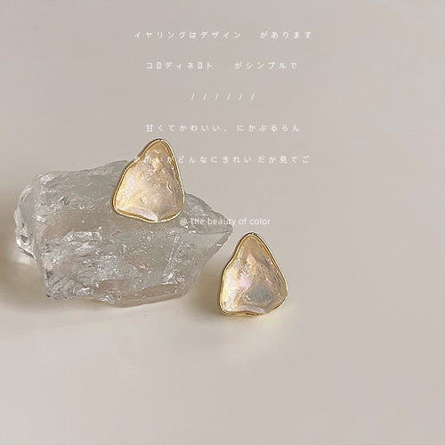 Gold-tone irregular translucent-cream stone-like studs in the first product display.