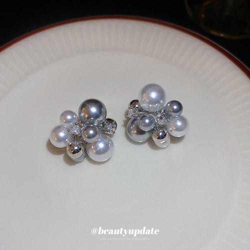 silver tone pearl cluster stud earrings displayed from a second angle