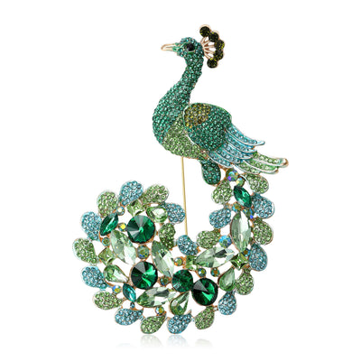 Two colorways of green and purple large peacock brooches shown side by side.