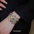 Gold Tone Wide Openwork Bracelet With Layered Textured Flowers And Leaves view 4