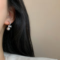Pair of Metal Tone Pink Pearl Bow Stud Earrings with Clear Crystals view 2