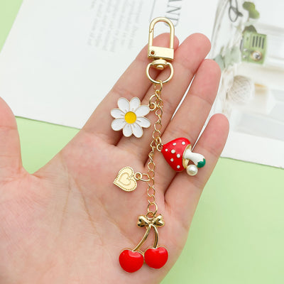 Image 1 showing a person holding up some charms on their fingers.