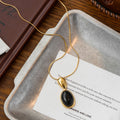 Oval Black Cabochon Pendant Necklace in Gold and Silver Tones view 6