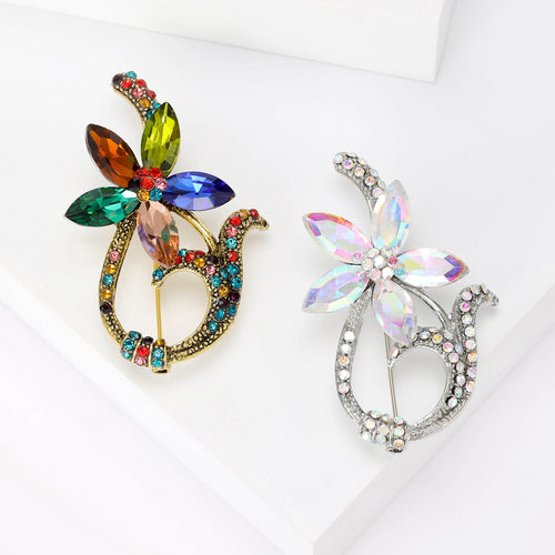 Front view of the glass petal wreath brooch in multicolor or clear with polished metal detail on a white background