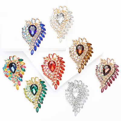 A large teardrop center framed by layered marquise crystals shown on a white background.