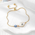 Gold Tone Blue Evil Eye Double-Dangle Slider Bracelets in Eight Designs view 8