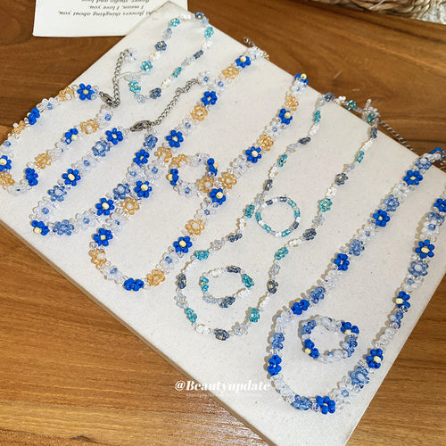 Assorted blue white coffee daisy bead necklaces bracelets rings tray