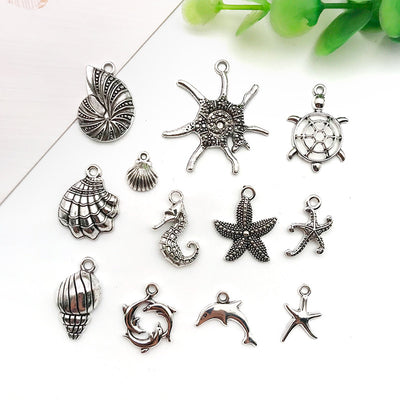 Metallic seashell charms arranged on a light background