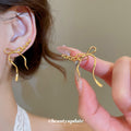 Bow Outline Drop Hook Earrings In Gold And Silver With Decorative Metal Details view 4