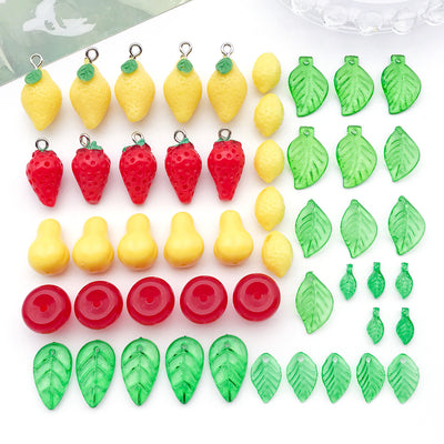 Multicolor lemon and leaf charms arranged on a light background
