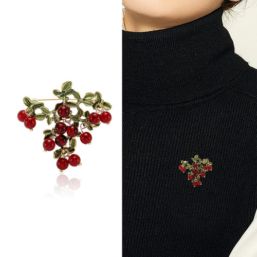 Red berry cluster brooch product shot and worn on black turtleneck
