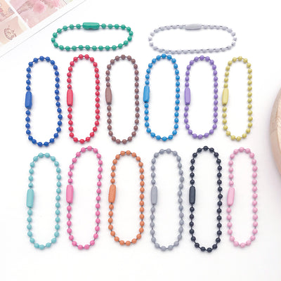 Colorful jewelry chain jewelry findings arranged on a light background