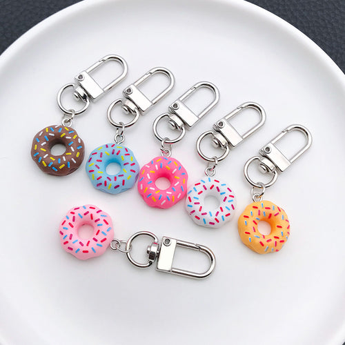 Styled close-up of colorful donut mini clip keychain showing colors and surface details