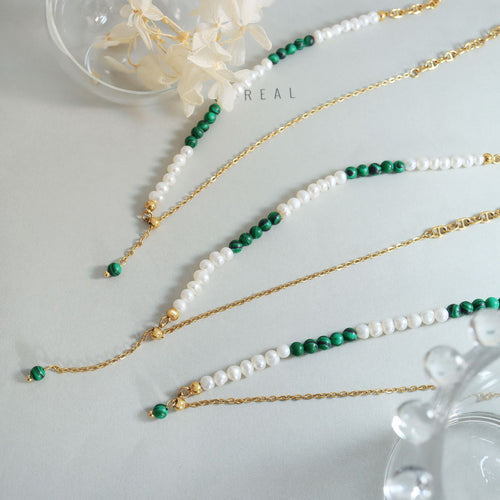 Flat lay multiple pearl green bead gold chain necklace styles