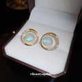 Round Opalescent Crystal Stud Earrings With Polished Metal Tone Details view 2