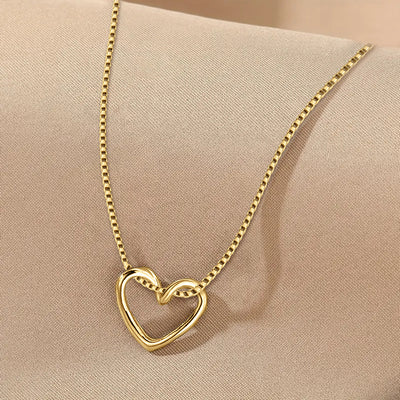 Front product view of interlocking open heart pendant necklace in gold tone finish