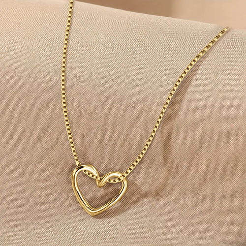Front product view of interlocking open heart pendant necklace in gold tone finish