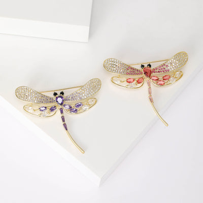Pink and purple gold rhinestone dragonfly brooches on white