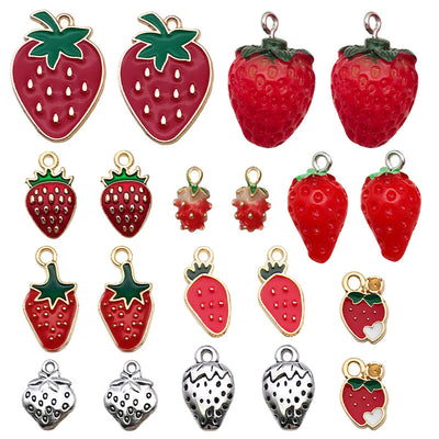Colorful strawberry charms arranged on a light background