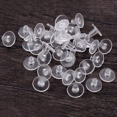 Image 1 showing clear soft plastic disc earring backs for stud posts, 10 x 6mm in the pictured colors and forms